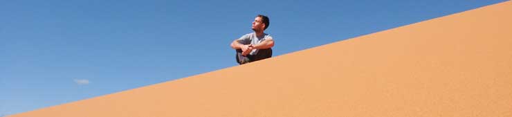 Tim sitting on Big Red, Simpson Desert